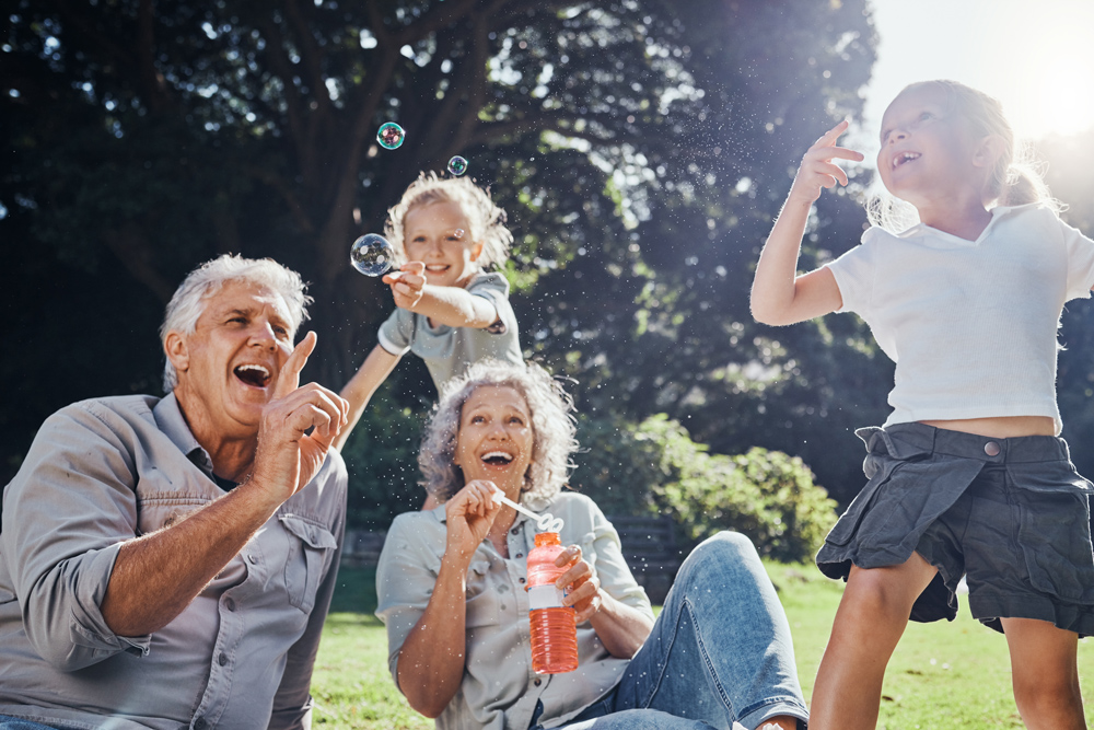 Retired, smiling senior couple with grandchildren